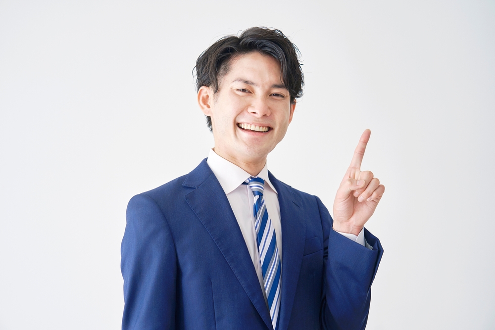 Asian,Businessman,Pointing,Side,In,White,Background